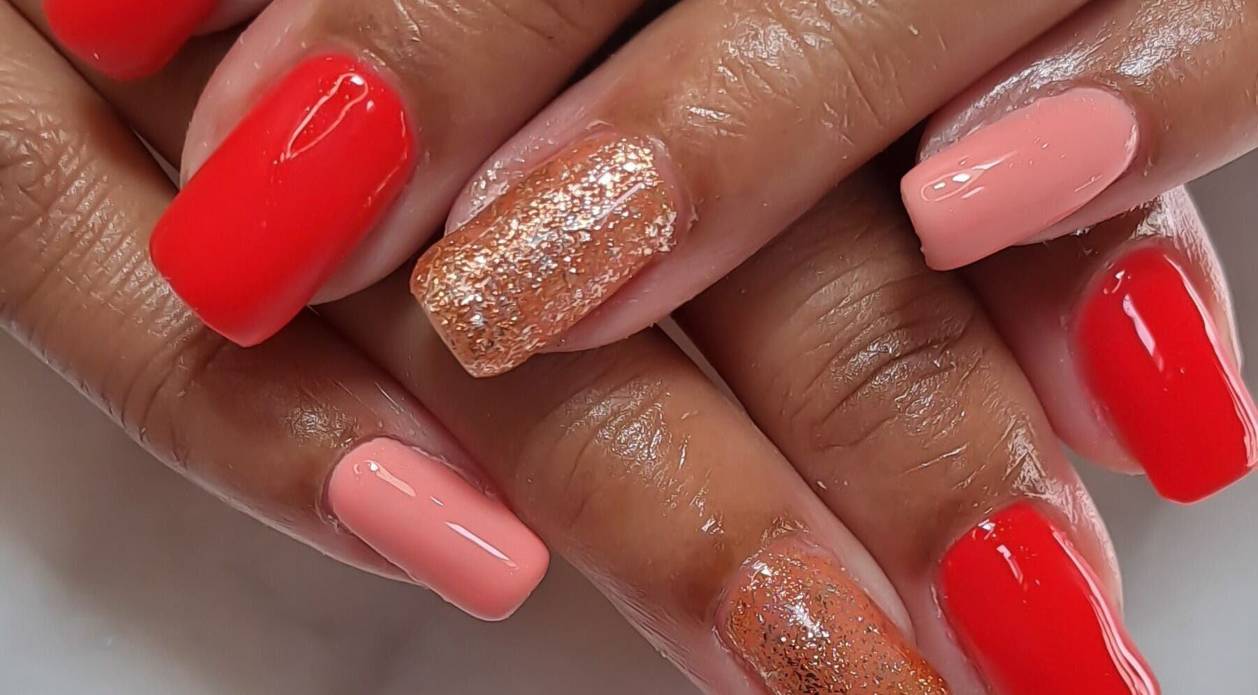 Elegant red and gold glitter nails at Minx nails & beauty, Cape Town, Western Cape, ZA.