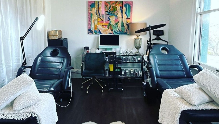 Modern treatment room at Cosmeticca Skin Clinic, Melbourne, Victoria, AU, featuring sleek black chairs and decor.