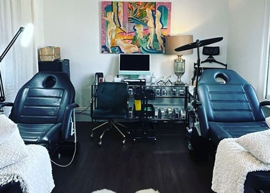 Modern treatment room at Cosmeticca Skin Clinic, Melbourne, Victoria, AU, featuring sleek black chairs and decor.