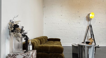 Chic lounge area at Cosmeticca Skin Clinic, Melbourne, Victoria, AU with modern decor and stylish lighting.