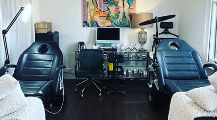 Treatment room at Cosmeticca Skin Clinic in Melbourne, Victoria, AU featuring two plush chairs and modern decor.