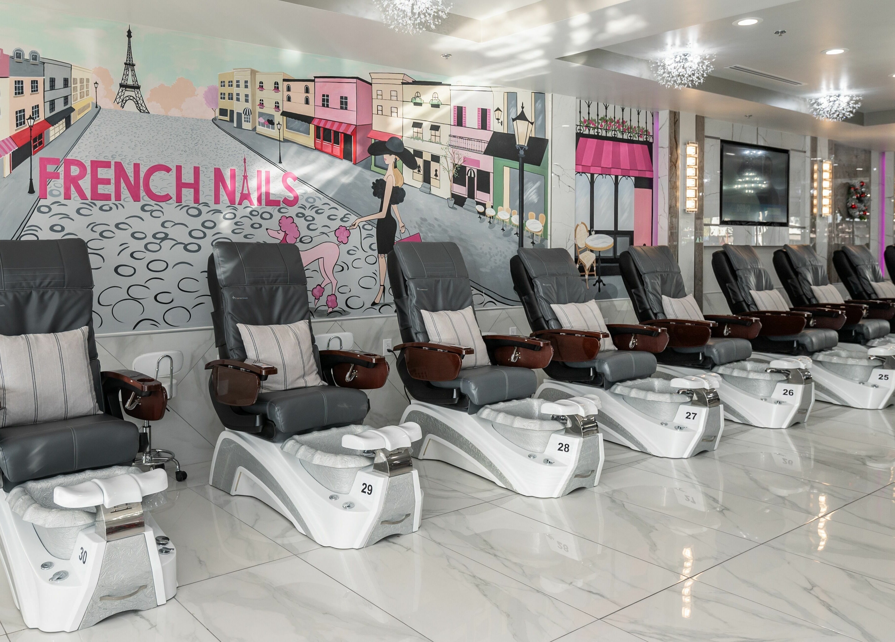 Luxury pedicure chairs at French Nails Luxury Spa and Bar, Dallas, Texas, US with vibrant wall art.