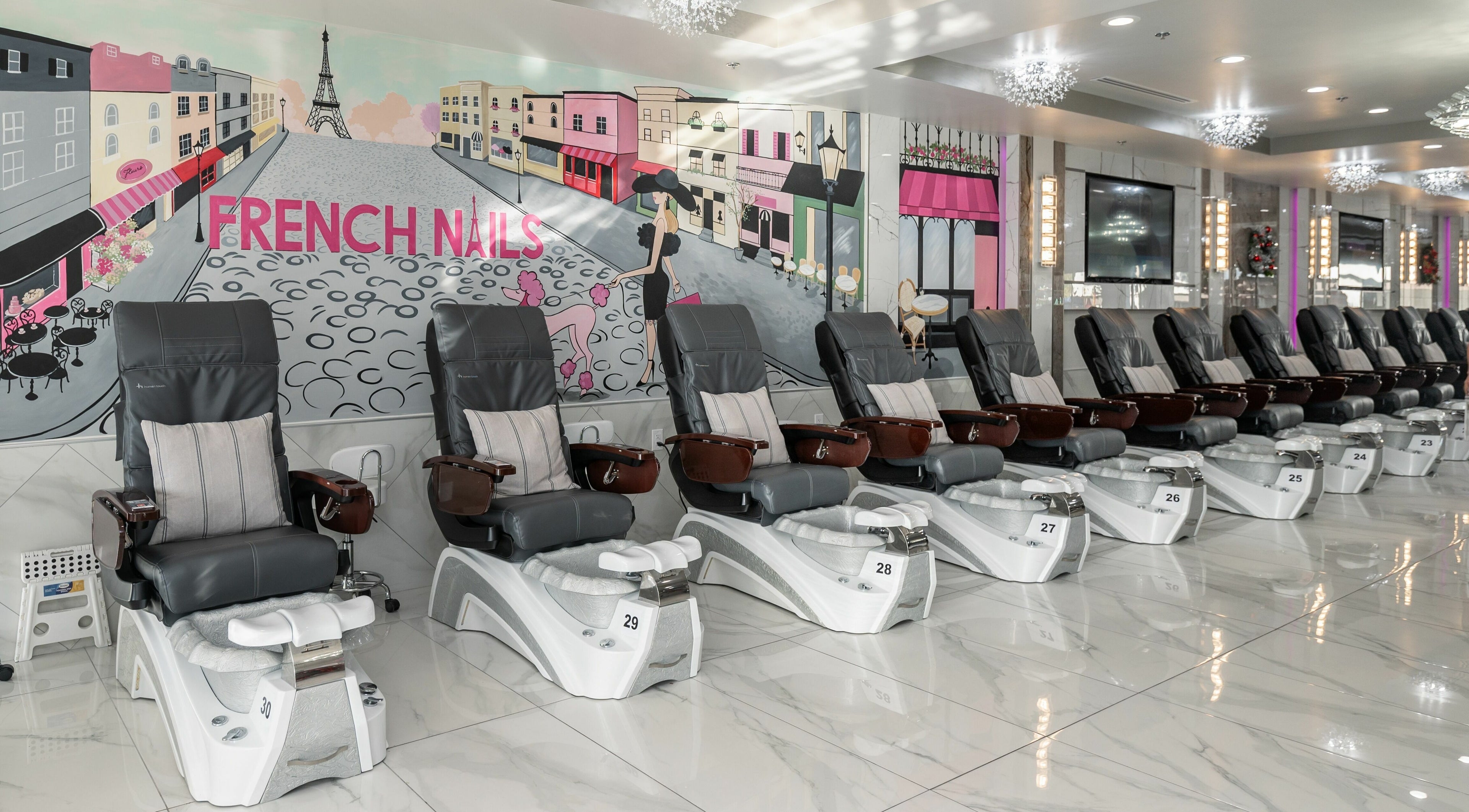 Luxury pedicure chairs at French Nails Luxury Spa and Bar, Dallas, Texas, US with vibrant wall art.