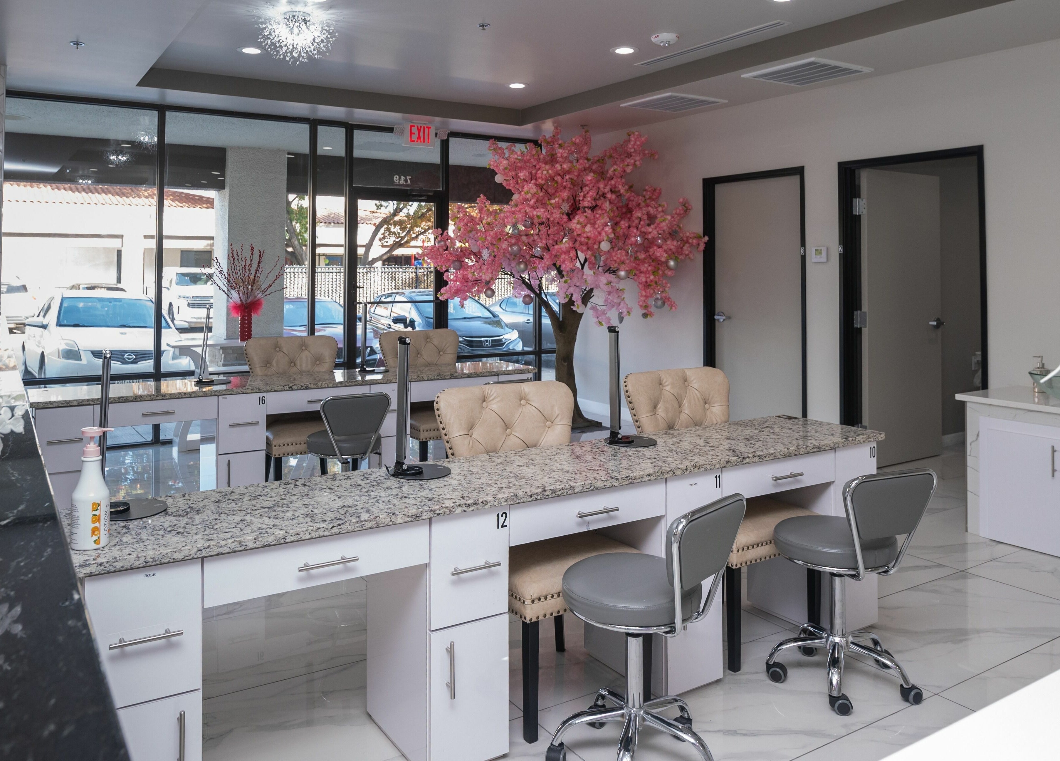 Luxurious nail station at French Nails Luxury Spa and Bar, Dallas, Texas, US featuring plush chairs and chic decor.