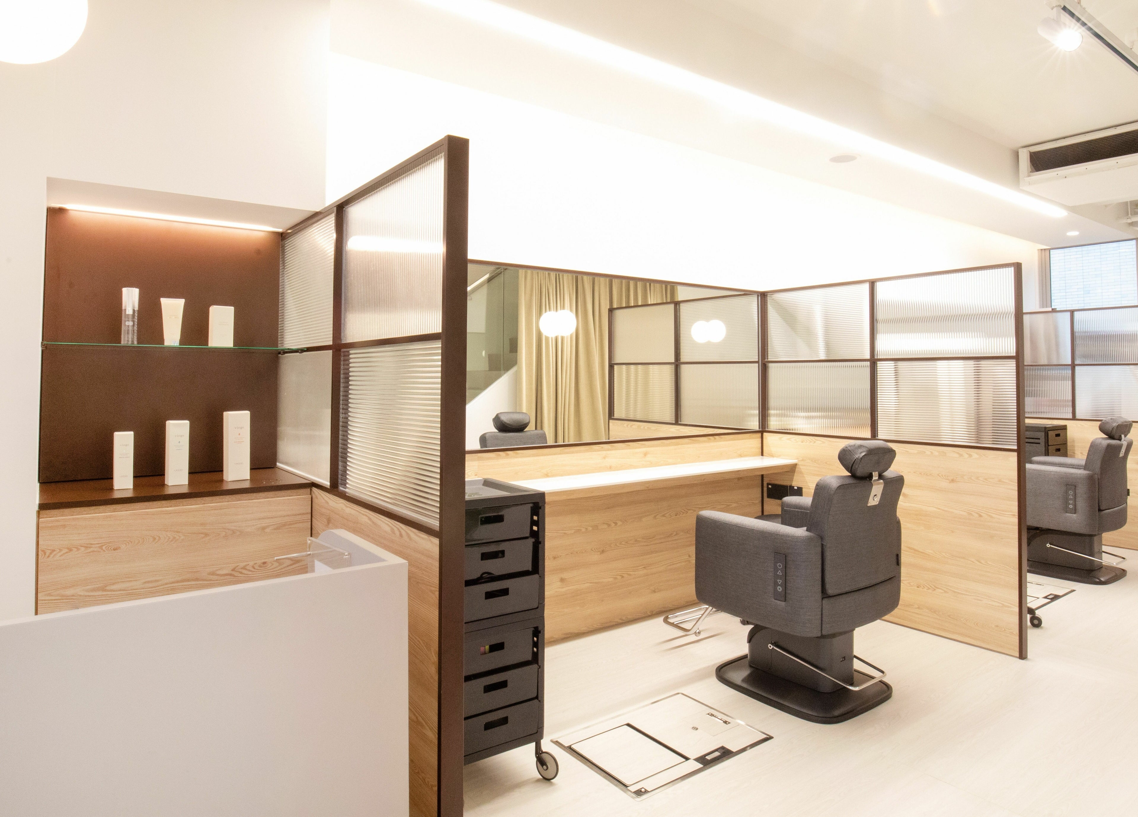 Modern salon interior of TCL Beauty Studio in Singapore, Singapore, SG with stylish chairs and wooden partitions.