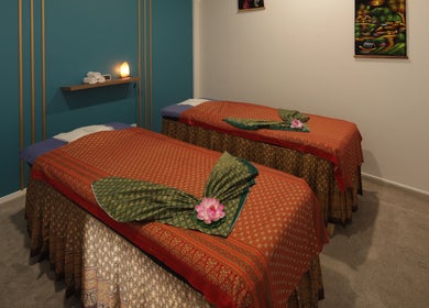 Twin massage beds at Naree Thai Massage in Auckland, NZ, featuring elegant decor and calming ambiance.