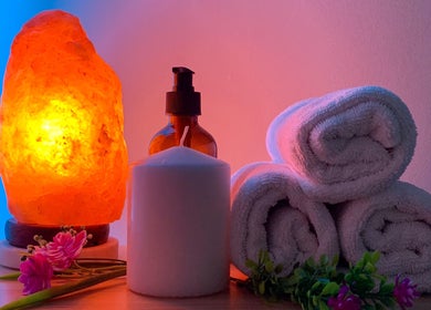 Atmospheric spa setup with salt lamp, candles, and towels at Naree Thai Massage, Auckland, NZ.