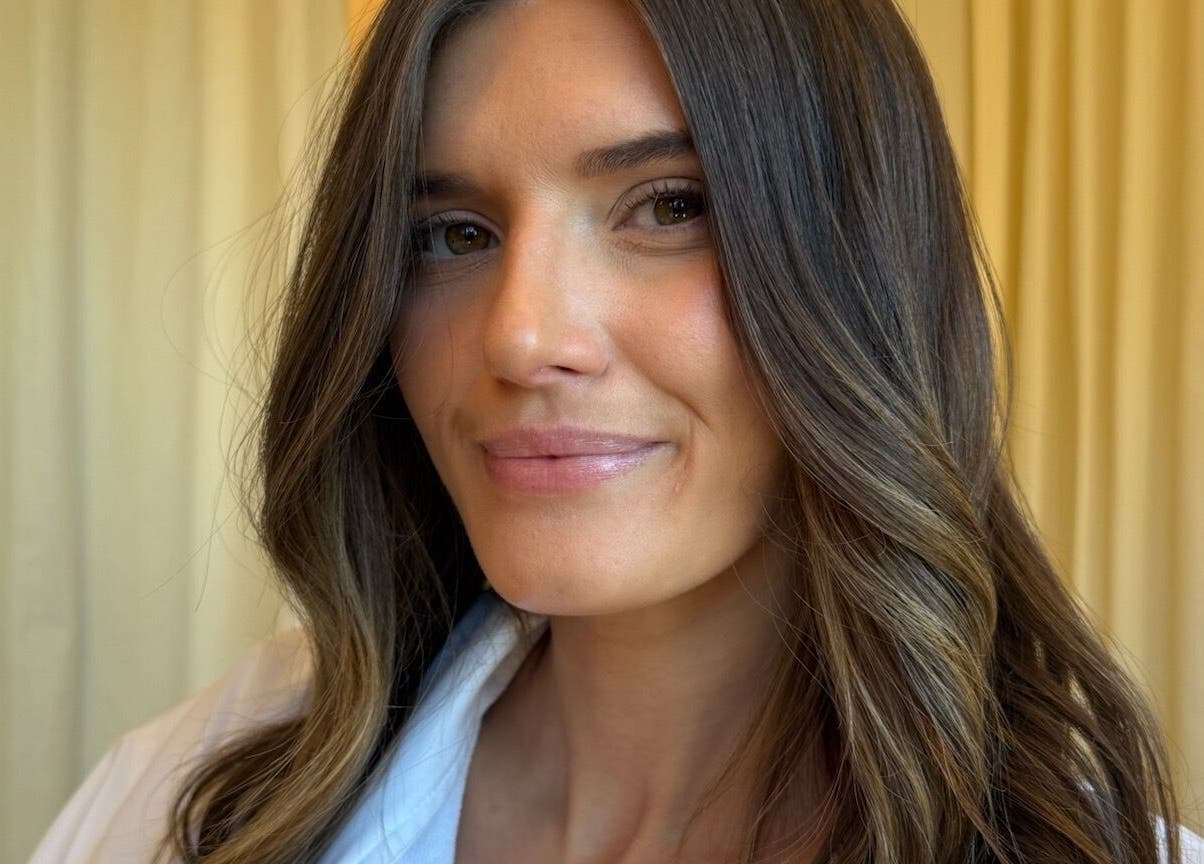 Smiling woman with styled hair at Tory Wells, Mascot, New South Wales, AU.