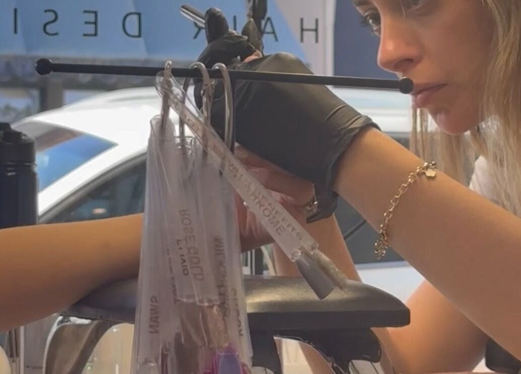 Professional nail technician at EKM Nails, Main Beach, Queensland, AU meticulously crafting nail designs.