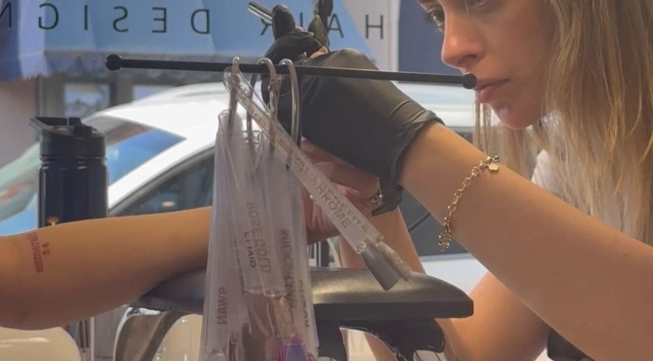 Professional nail technician at EKM Nails, Main Beach, Queensland, AU meticulously crafting nail designs.