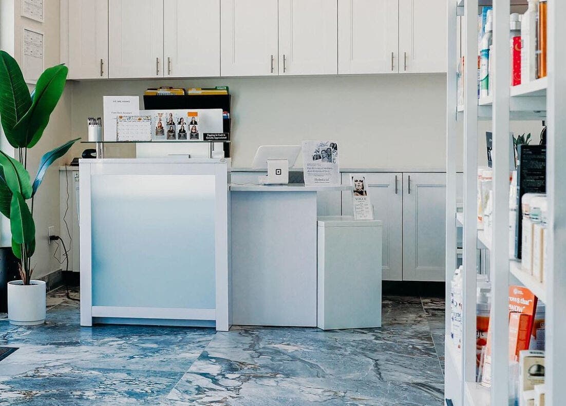 Reception area at Vogue Lashes & Spa - Greenbrier, Chesapeake, Virginia, US with modern decor and open shelving.