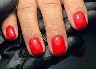 Close-up of red manicured nails at Edit By ELM, Binfield, England, GB. Vibrant and glossy finish.