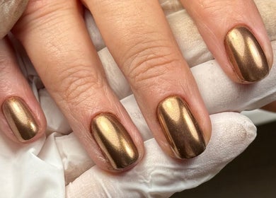 Elegant gold manicure at Edit By ELM in Binfield, England, GB showcasing glossy metallic finish.