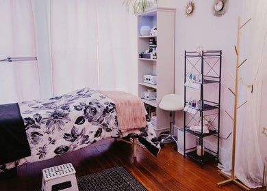 Serene treatment room at Get Up and Glow Beauty Studio, Chehalis, Washington, US with floral decor and skincare products.