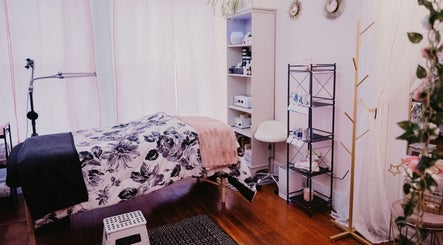 Serene treatment room at Get Up and Glow Beauty Studio, Chehalis, Washington, US with floral decor and skincare products.