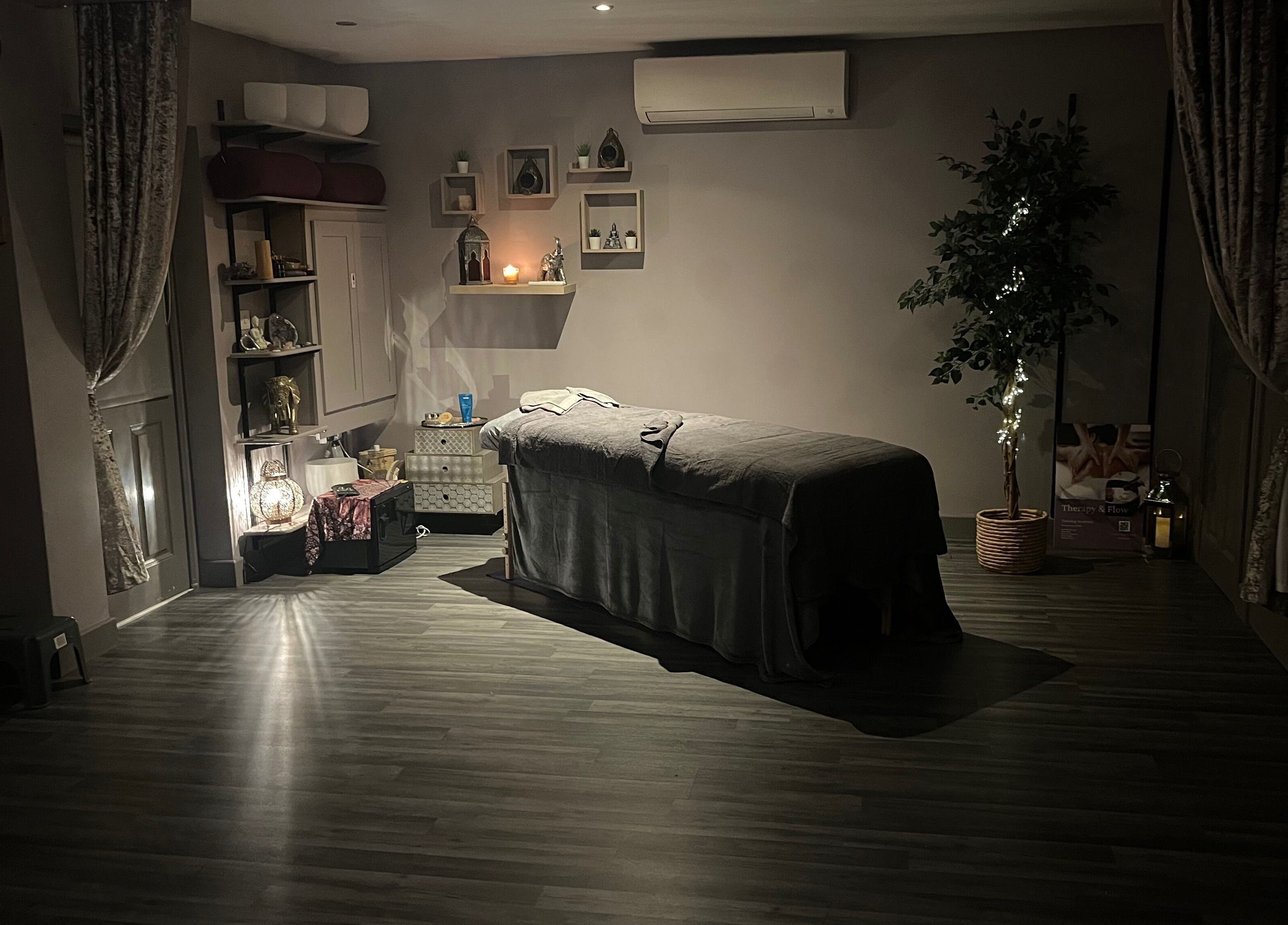 Relaxing massage room at Therapy & Flow in Birmingham, England, GB with dim lighting and calming decor.
