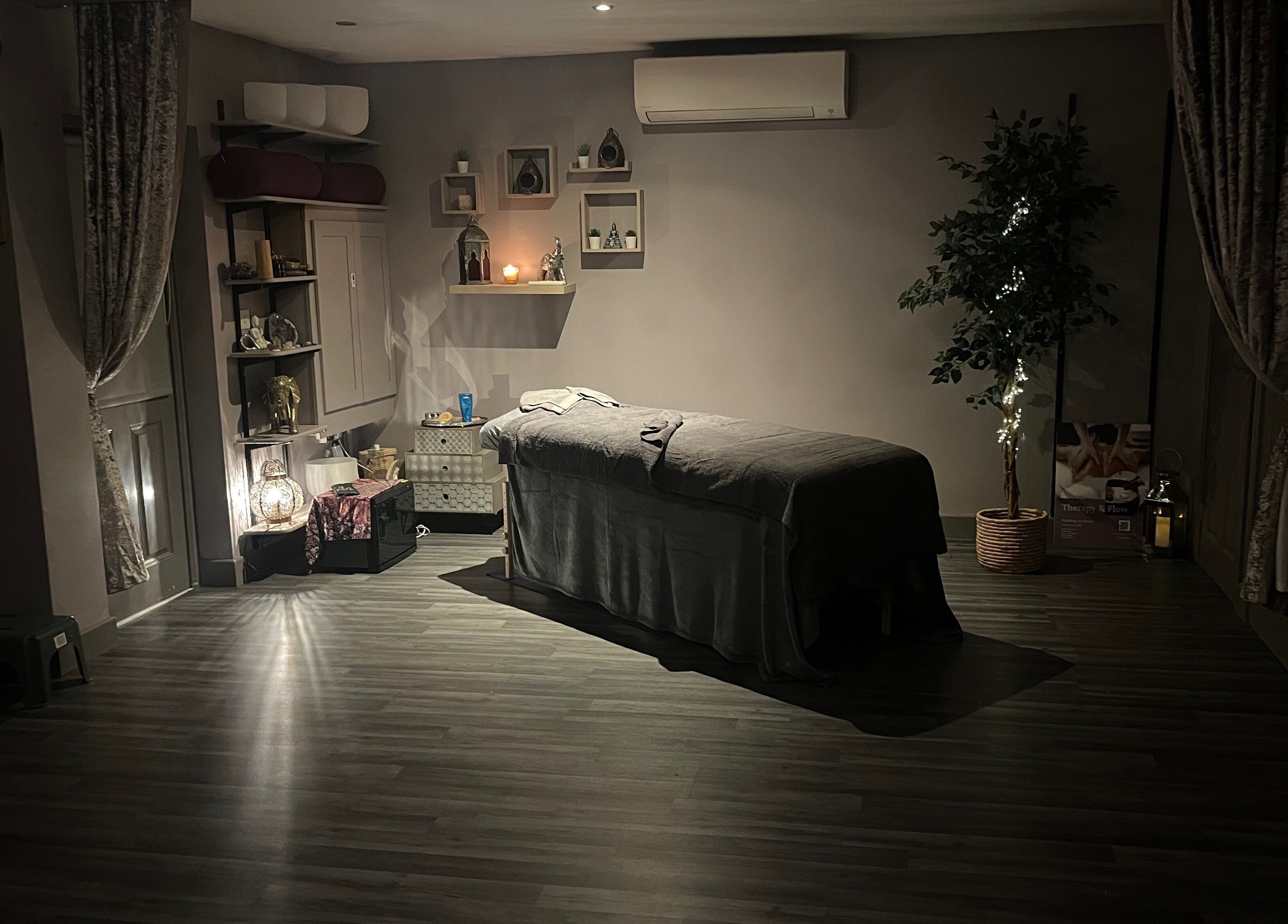 Relaxing massage room at Therapy & Flow in Birmingham, England, GB with dim lighting and calming decor.