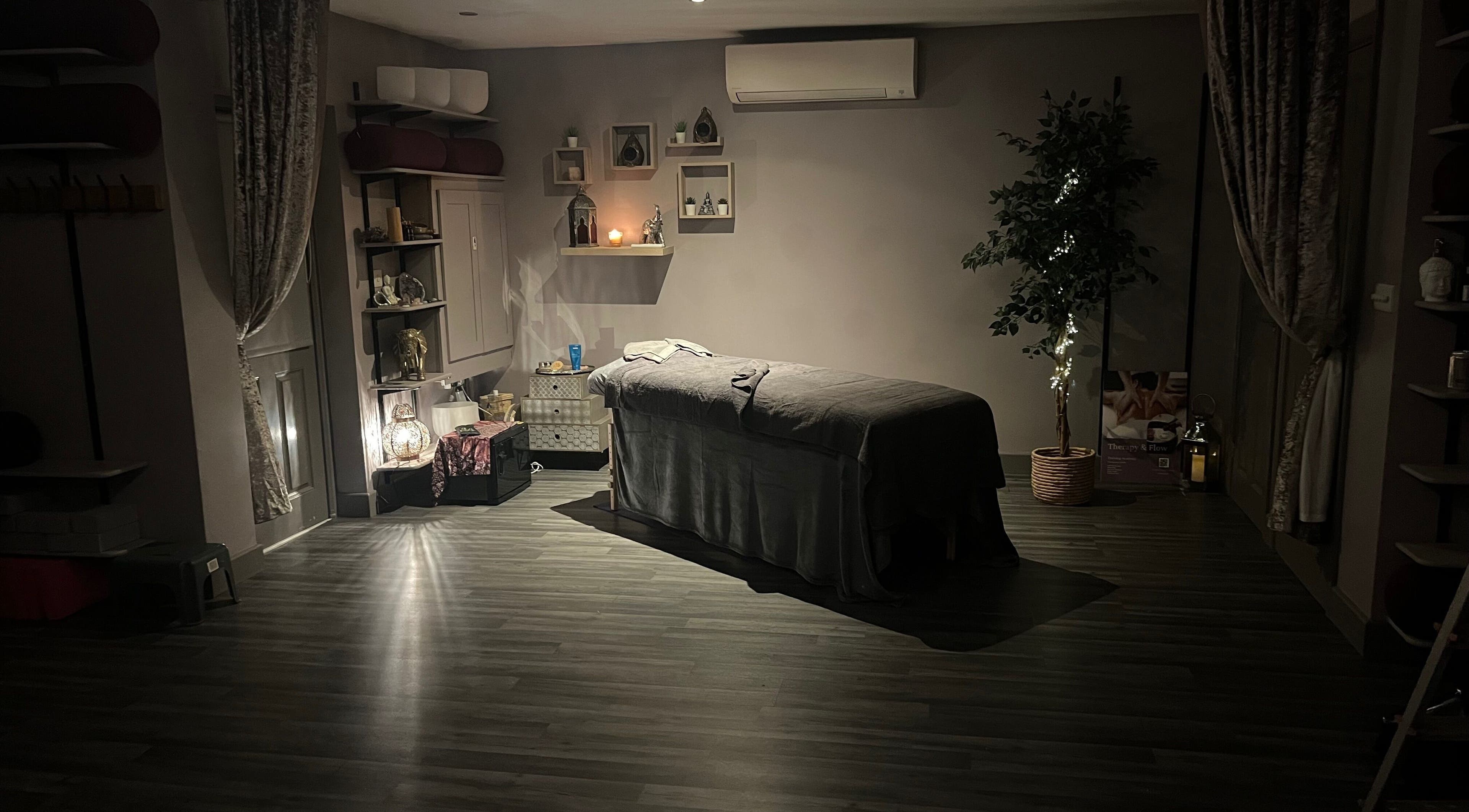 Relaxing massage room at Therapy & Flow in Birmingham, England, GB with dim lighting and calming decor.