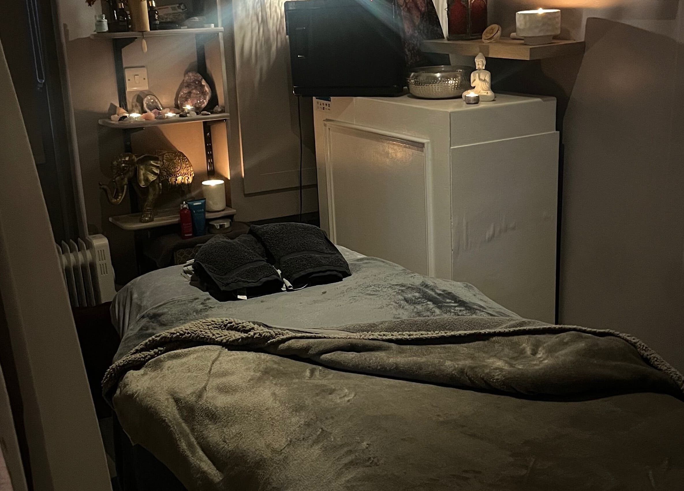 Cozy massage room in Therapy & Flow, Birmingham, England, GB, with soft lighting and plush decor.