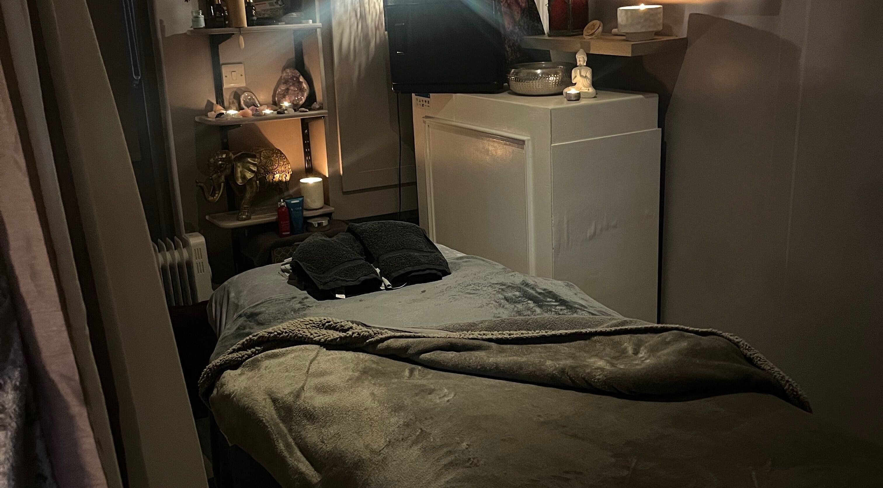 Cozy massage room in Therapy & Flow, Birmingham, England, GB, with soft lighting and plush decor.