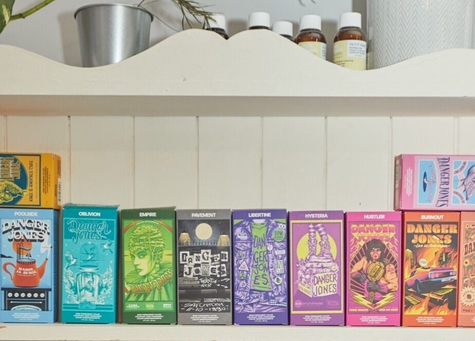 Colorful product boxes neatly arranged on a shelf at Wonderland Hair Cheltenham, Cheltenham, England, GB.