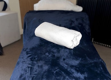 Plush massage table at The Body Massage Guru in Manchester, England, GB exudes relaxation and luxury.