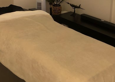 Cozy massage bed at The Body Massage Guru in Manchester, England, GB, ready for a relaxing session.