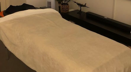 Cozy massage bed at The Body Massage Guru in Manchester, England, GB, ready for a relaxing session.