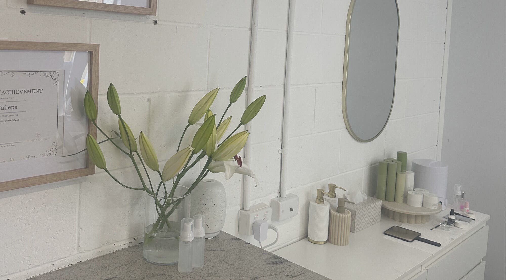 Elegant setup at Lmv Studio, Mermaid Waters, Queensland, AU, featuring lilies and beauty products.