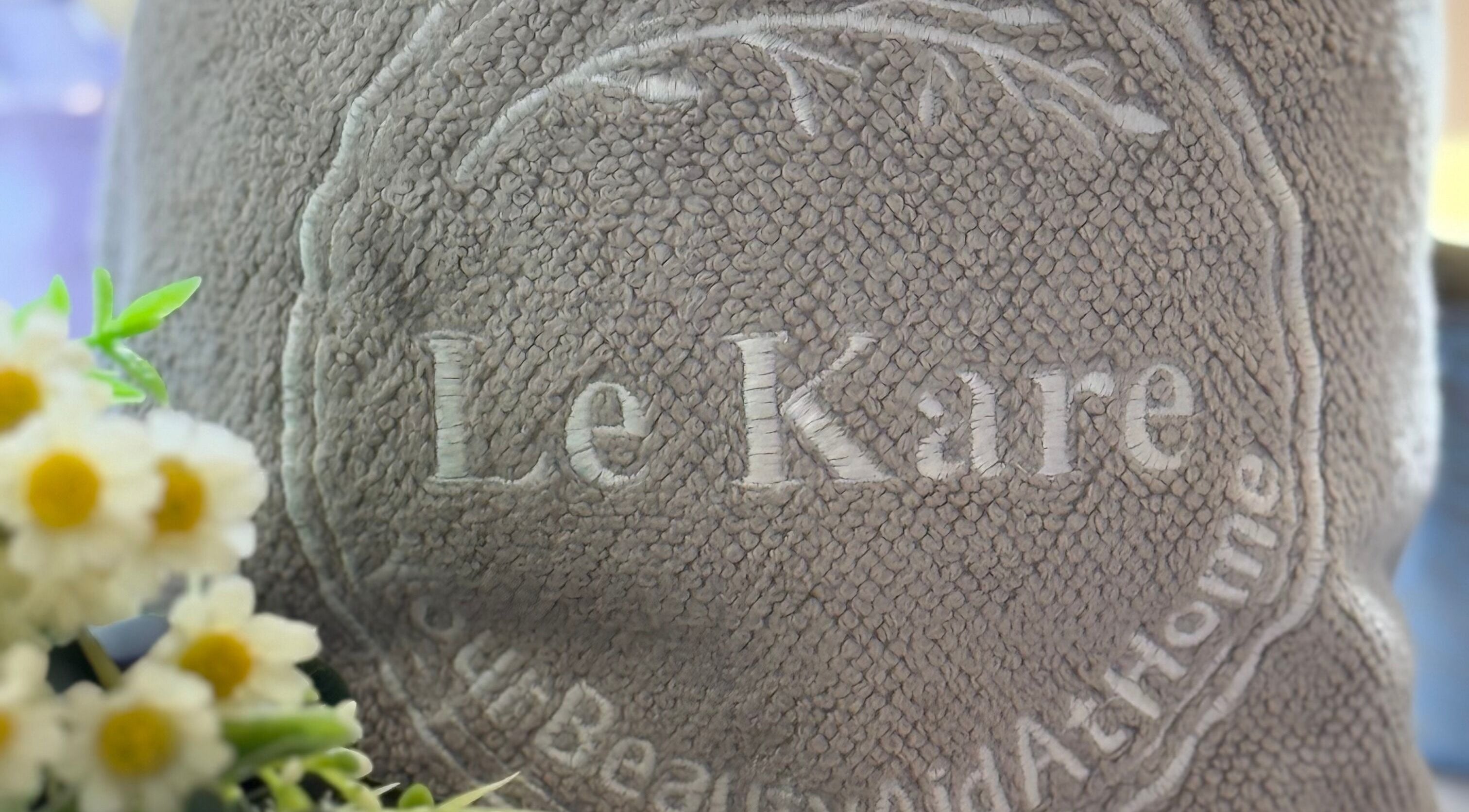 Le Kare Spa - Home Service Jeddah logo on plush towel in Jeddah, SA, showcasing premium spa experience.