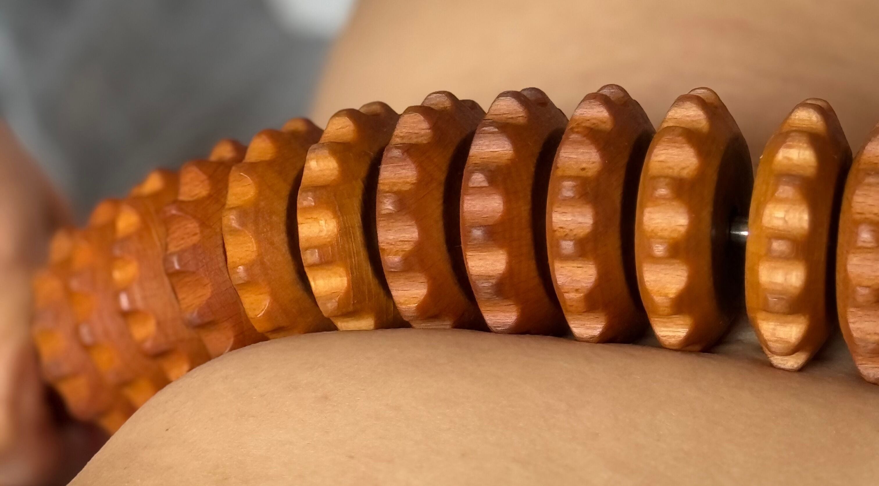 Wooden massage roller in use at Le Kare Spa - Home Service Jeddah, Jeddah, SA for a therapeutic experience.