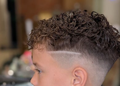Styled curly haircut at Sandi Hair Studio, Greater, Atherton, England, GB. Trendy salon experience.