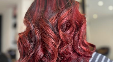 Vibrant red curls styled at Sandi Hair Studio in Greater, Atherton, England, GB.