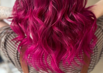 Vibrant pink hair waves styled at Sandi Hair Studio, Greater, Atherton, England, GB, showcasing expert coloring.