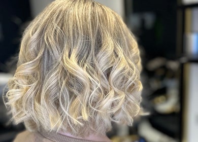 Elegant blonde curls styled at Sandi Hair Studio in Greater, Atherton, England, GB.