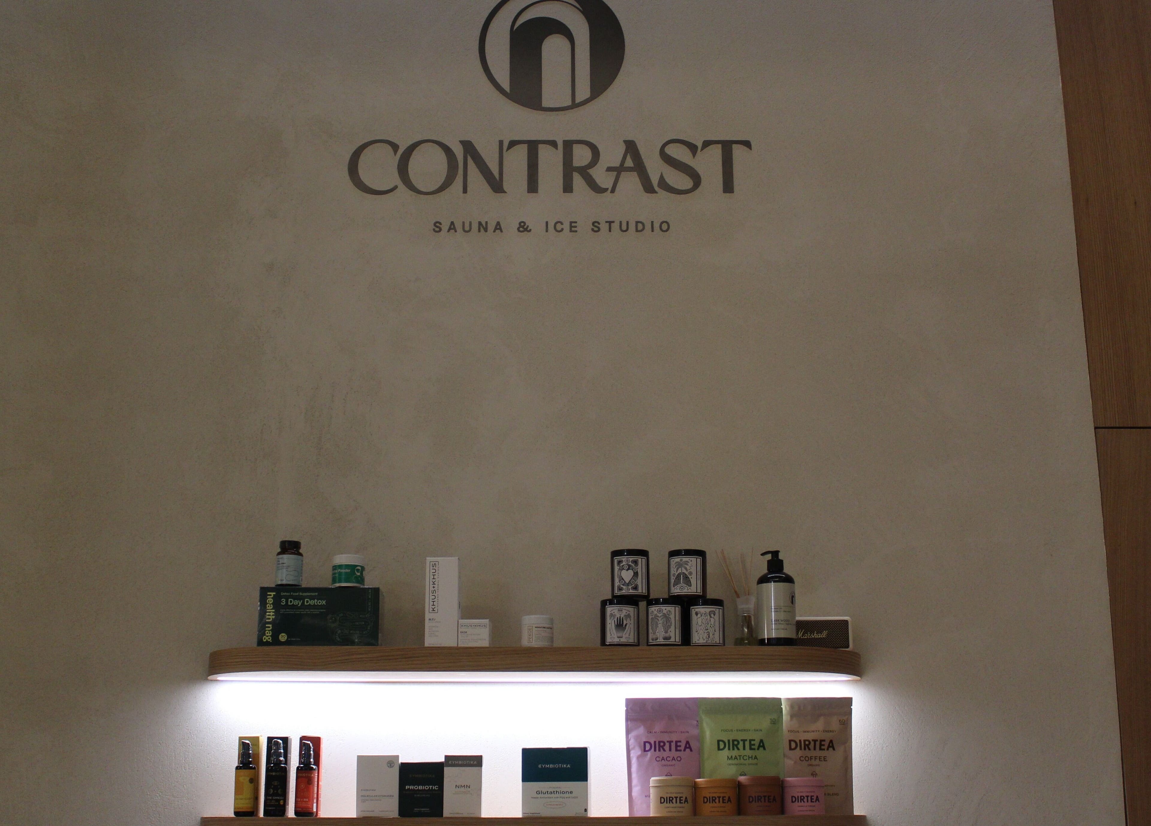 Contrast JVC display of wellness products in دبي, دبي, AE. Elegant shelf showcasing beauty items and teas.