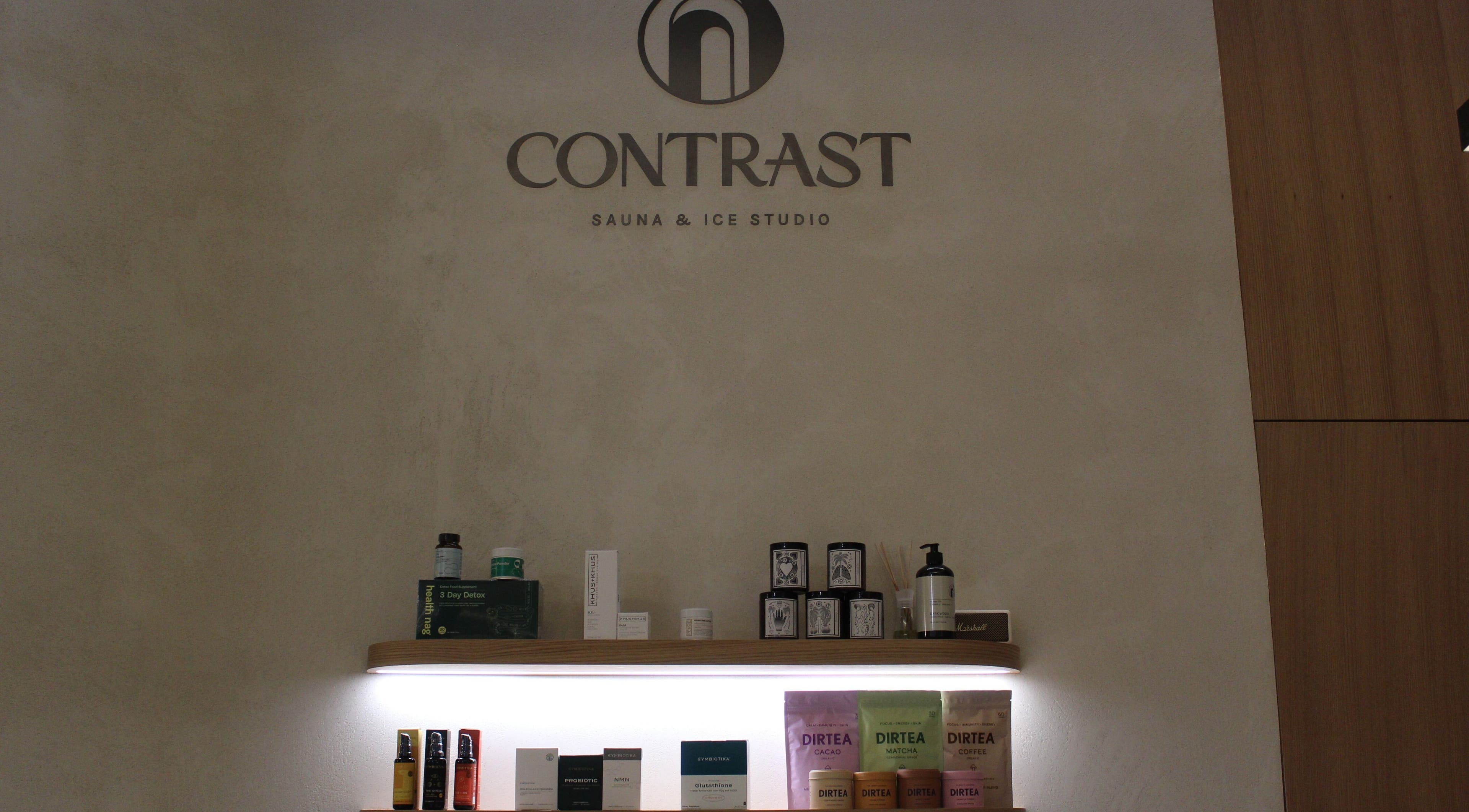 Contrast JVC display of wellness products in دبي, دبي, AE. Elegant shelf showcasing beauty items and teas.