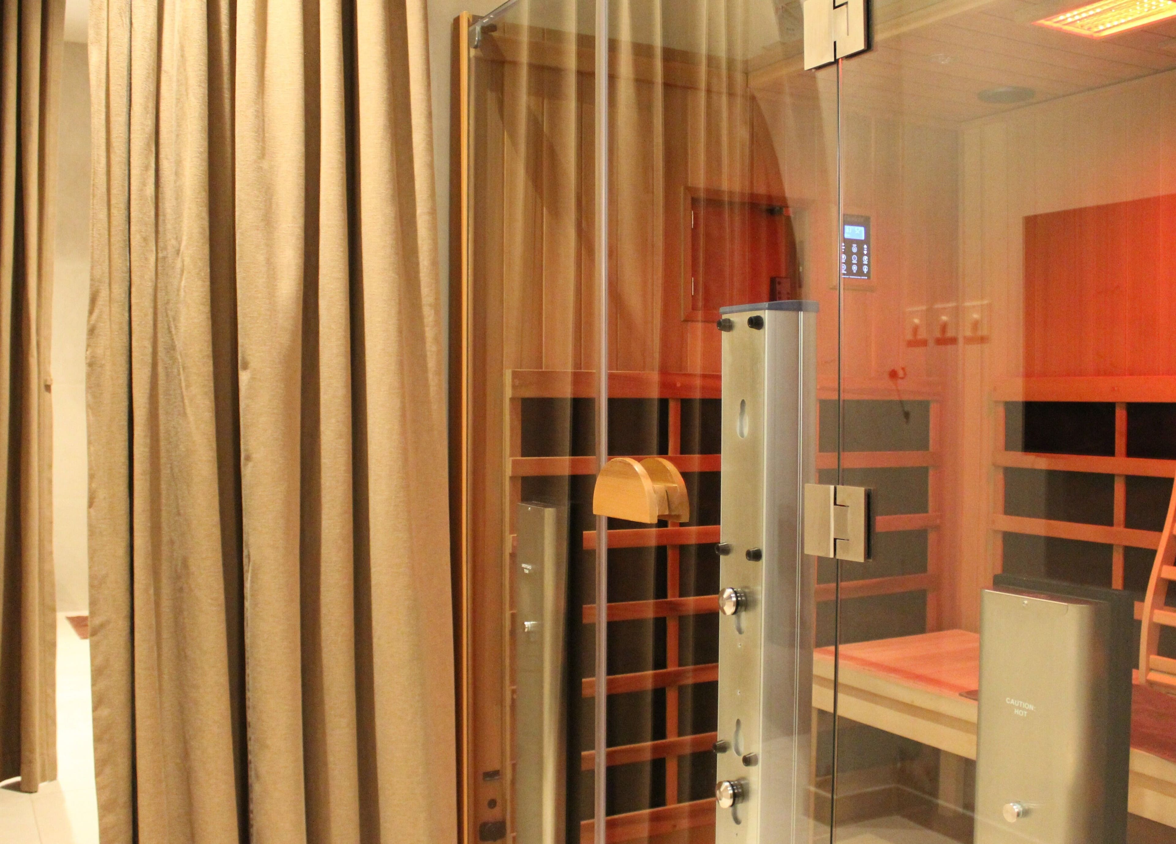 Luxurious sauna room at Contrast JVC, دبي, دبي, AE, featuring elegant wood and soft lighting.