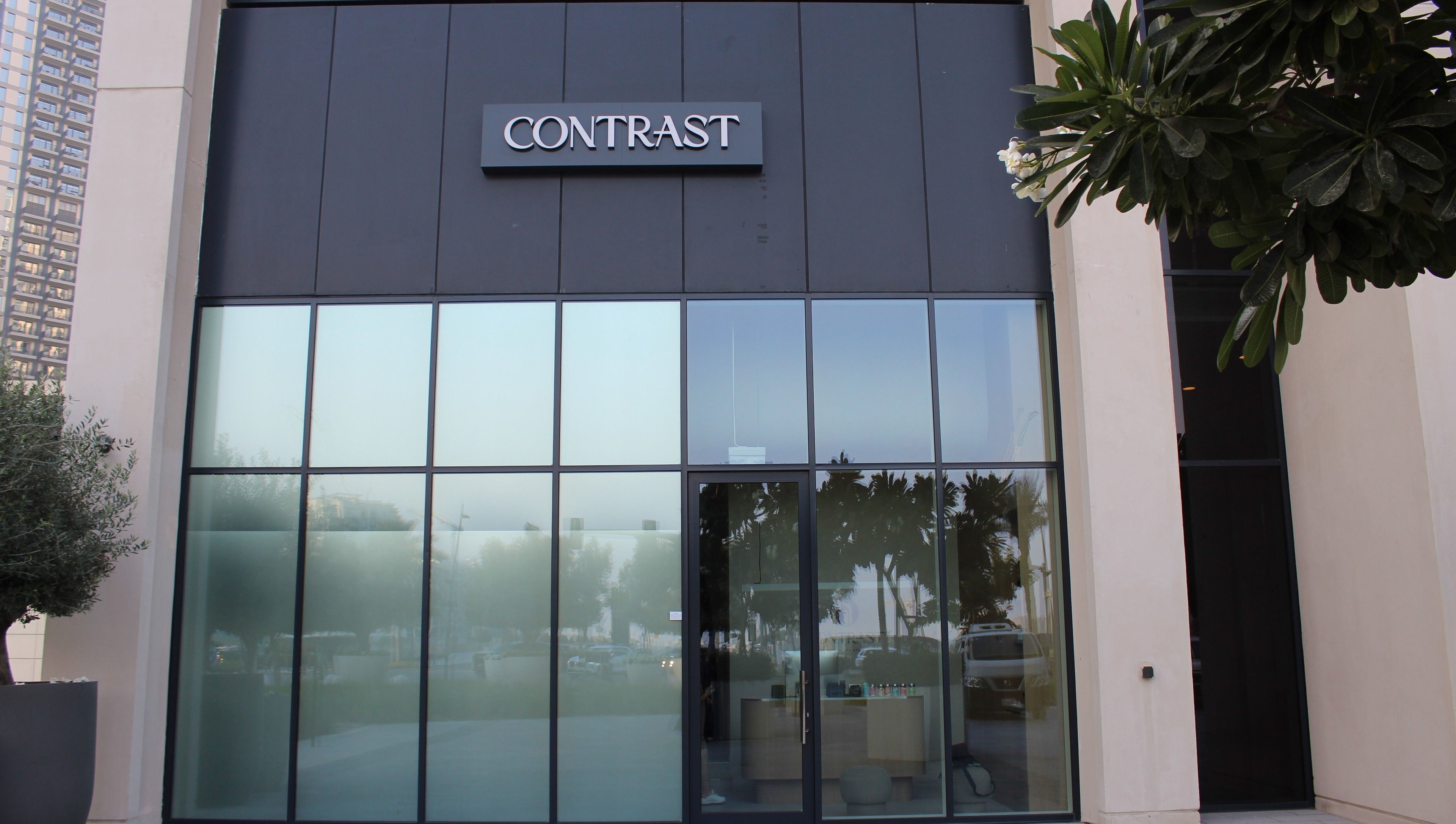 Entrance of Contrast Dubai Creek Harbour in Dubai, Dubai, AE with modern glass facade.