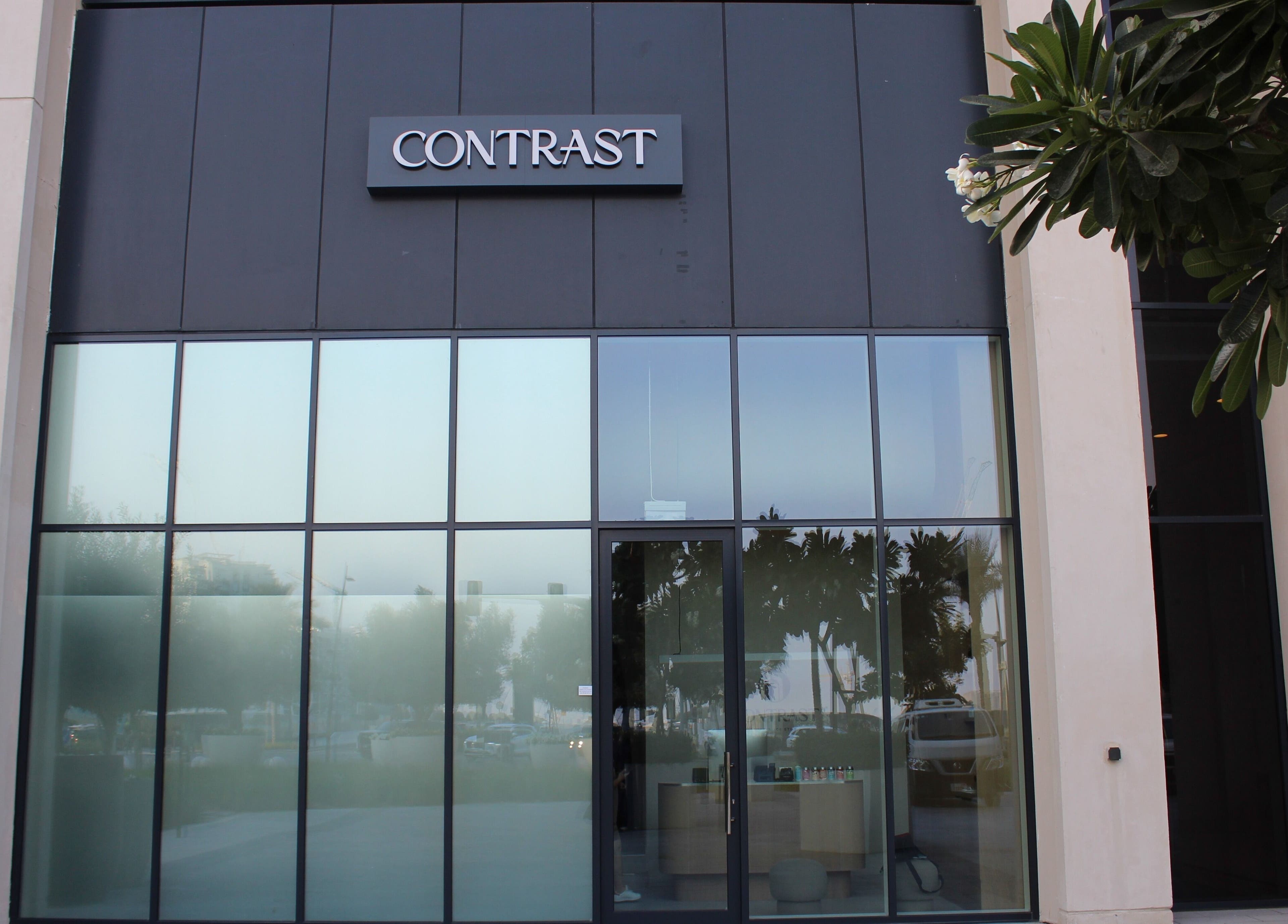 Entrance of Contrast Dubai Creek Harbour in Dubai, Dubai, AE with modern glass facade.