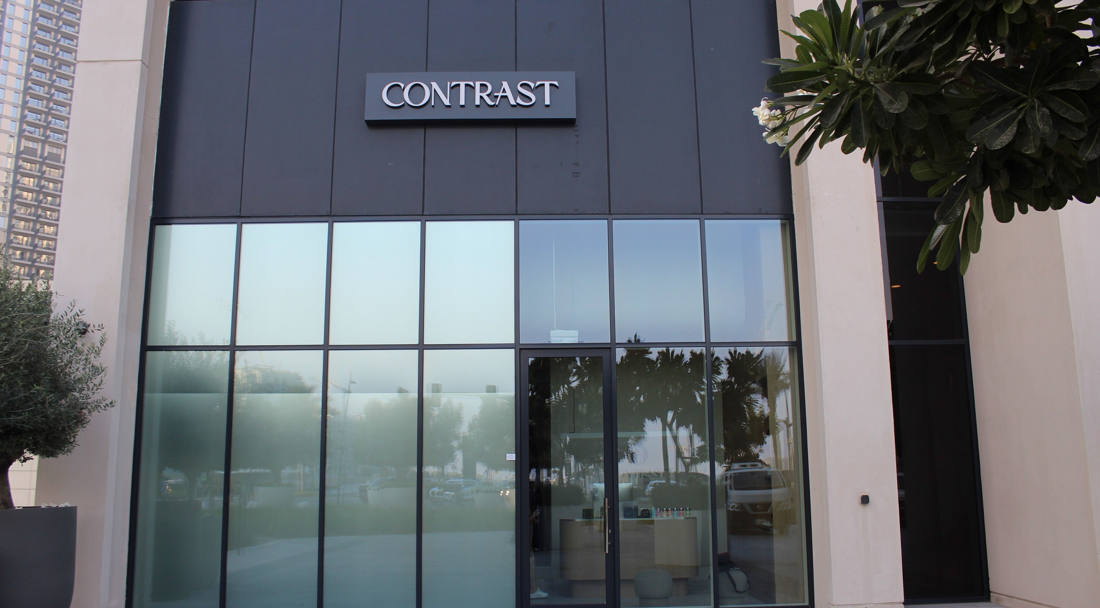 Entrance of Contrast Dubai Creek Harbour in Dubai, Dubai, AE with modern glass facade.