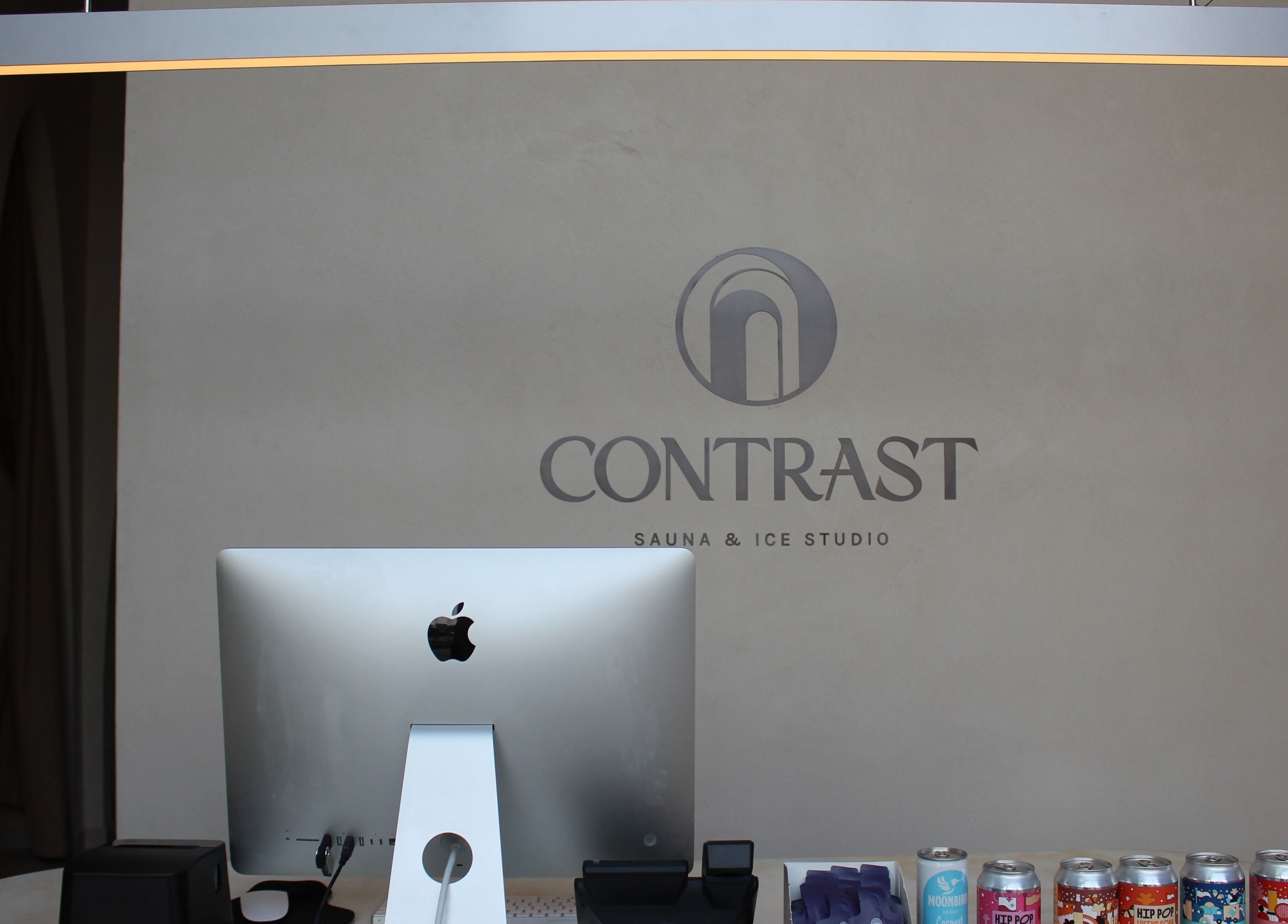 Reception desk at Contrast Dubai Creek Harbour spa, Dubai, Dubai, AE with modern design and refreshments.