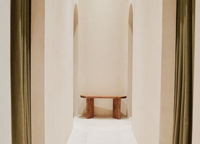 Arched hallway with wooden bench at Contrast Palm Jumeirah, Dubai, Dubai, AE, offering serene elegance.