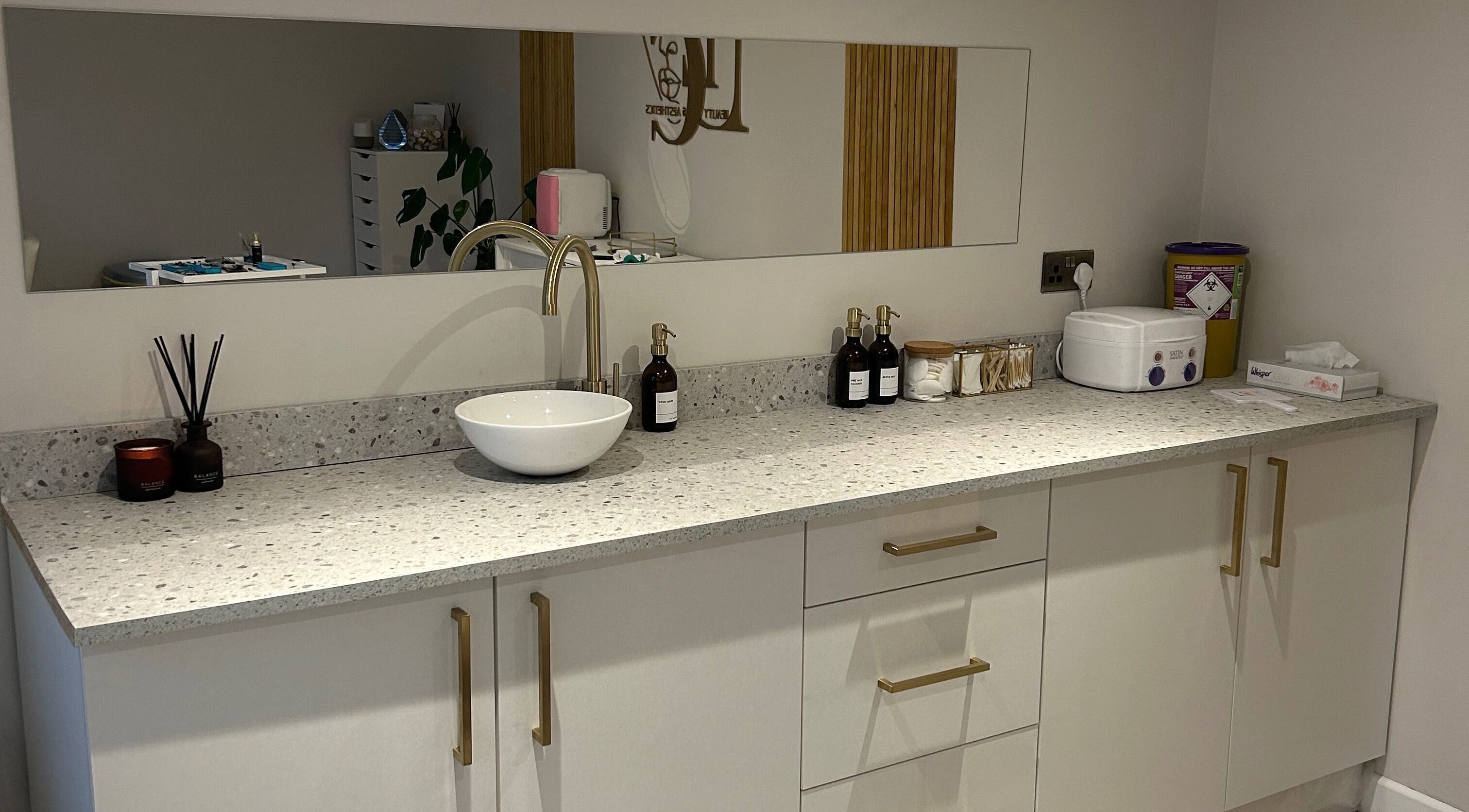 Elegant sink area at DLC Beauty and Aesthetics, Hatfield, England, GB featuring modern decor and toiletries.