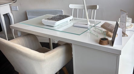 Elegant manicure station at Inspire Nails, Studley, England, GB, showcasing modern decor and comfortable seating.