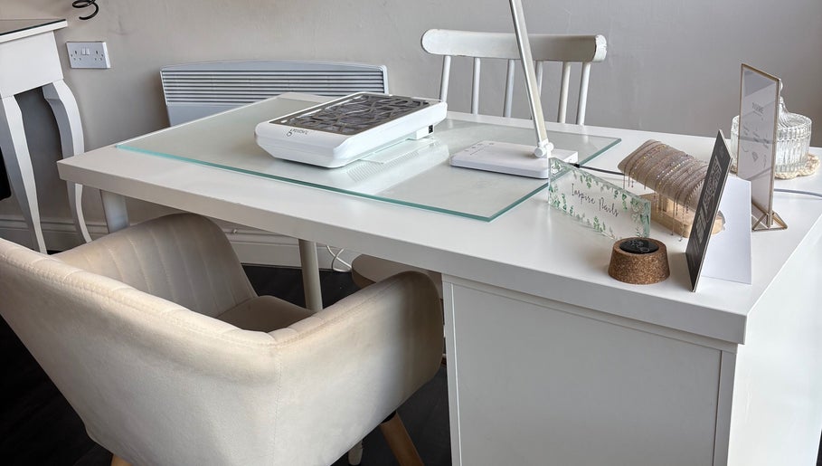 Modern nail station setup at Inspire Nails, Studley, England, GB with manicure equipment and elegant decor.