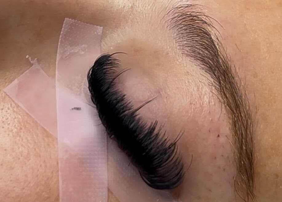 Close-up of eyelash extension application at Deebeautystop in London, England, GB.