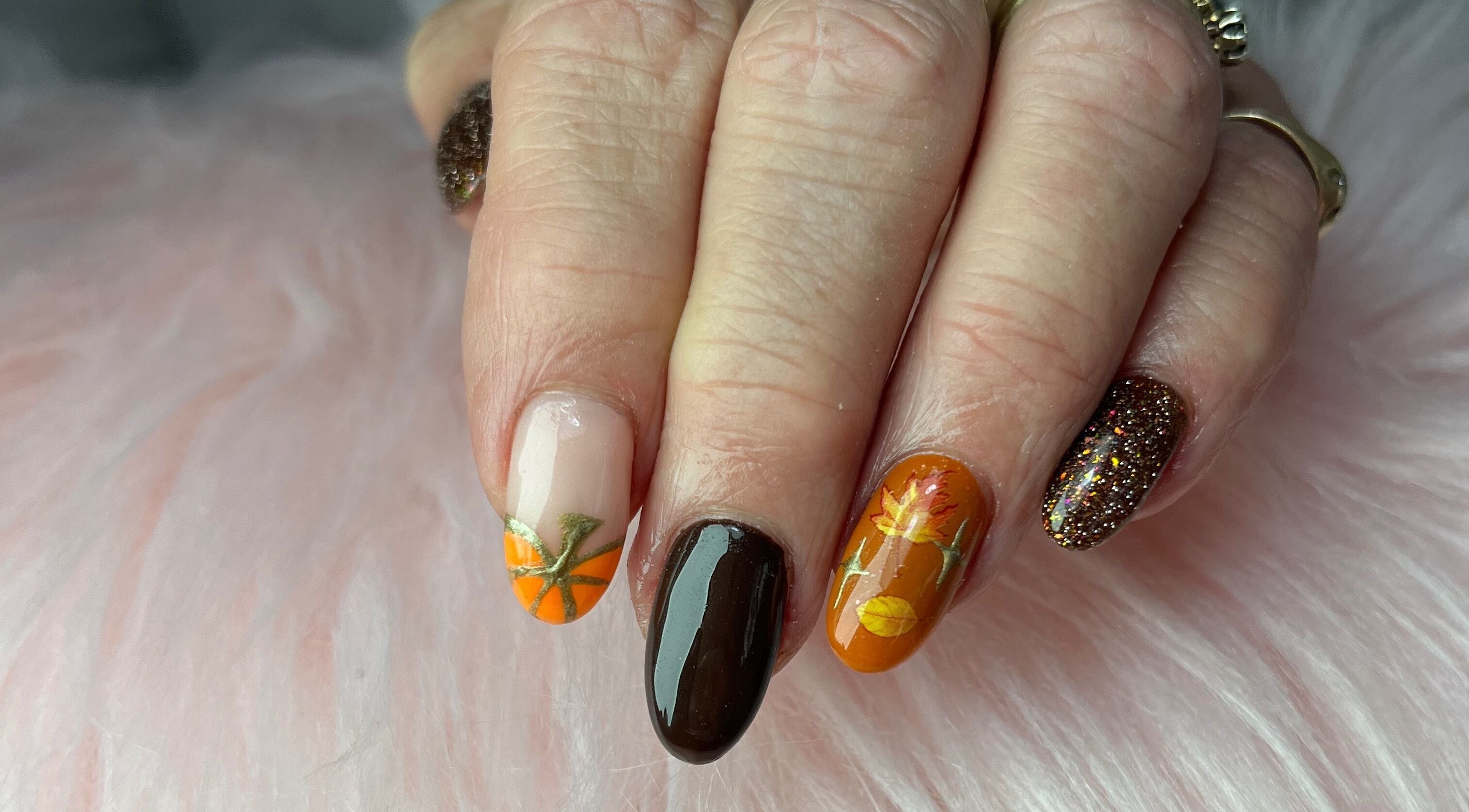 Autumn-themed nails with glitter at Nails by Freya, Prestatyn, Wales, GB. Perfect for seasonal charm.