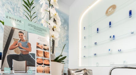 Evolve X poster and orchids at Starlight Med Spa Toronto, Toronto, Ontario, CA. Promotes body transformation.