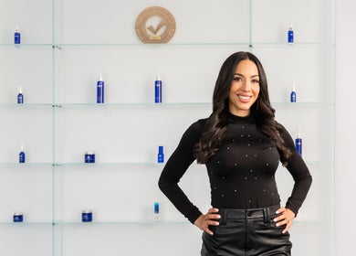 Professional at Starlight Med Spa Toronto, Ontario, CA with elegant display of wellness products.